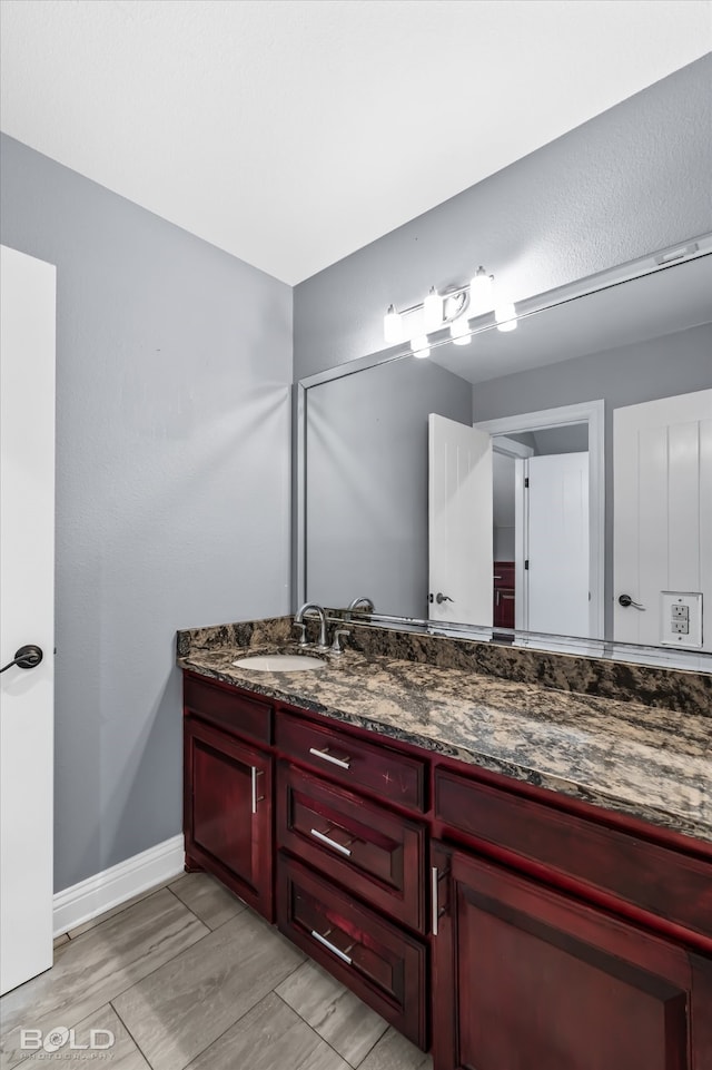 bathroom with wood-type flooring and vanity