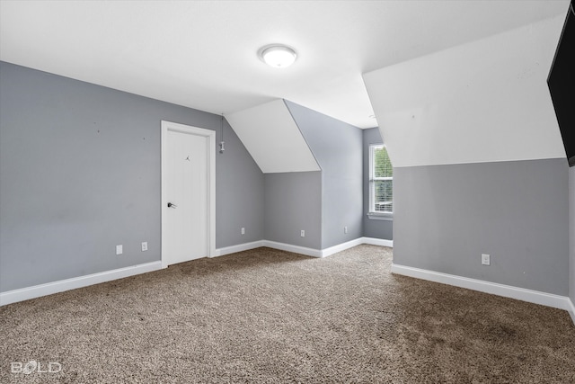 additional living space featuring carpet flooring and lofted ceiling