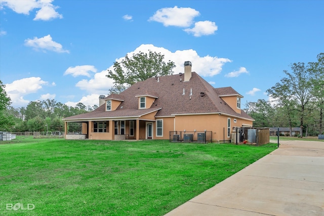 back of property featuring a lawn