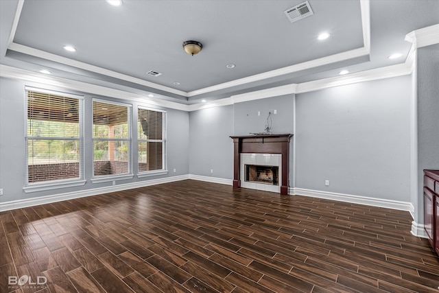 unfurnished living room featuring crown molding, dark hardwood / wood-style flooring, and a tray ceiling