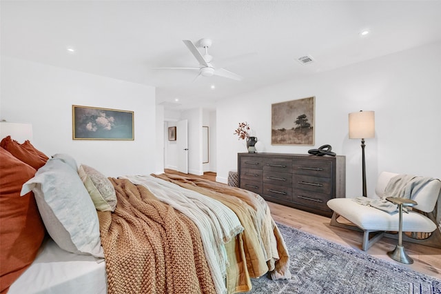 bedroom with ceiling fan and hardwood / wood-style floors