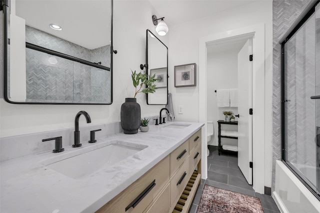 full bathroom featuring shower / bath combination with glass door, tile patterned floors, vanity, and toilet