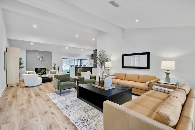 living room featuring light hardwood / wood-style floors and vaulted ceiling