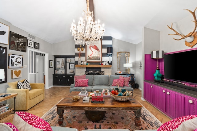 living room with light parquet flooring, a chandelier, vaulted ceiling, and a brick fireplace