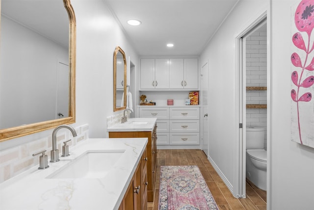 7117 Serrano Dr, Benbrook, TX 76126 - bathroom featuring recessed lighting, wood finished floors, toilet, and two vanities