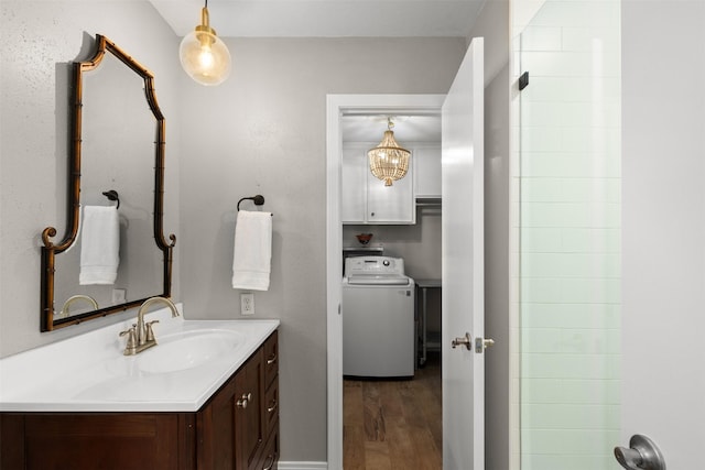 7117 Serrano Dr, Benbrook, TX 76126 - bathroom featuring washer / dryer, wood finished floors, and vanity