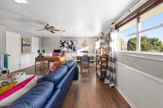 living room featuring dark hardwood / wood-style floors and ceiling fan