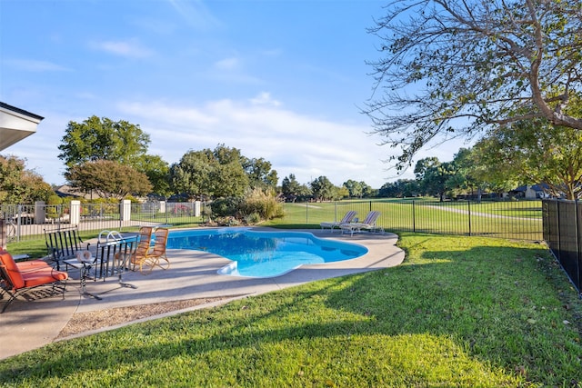 view of pool with a patio and a yard