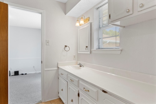 bathroom featuring tile patterned flooring and vanity