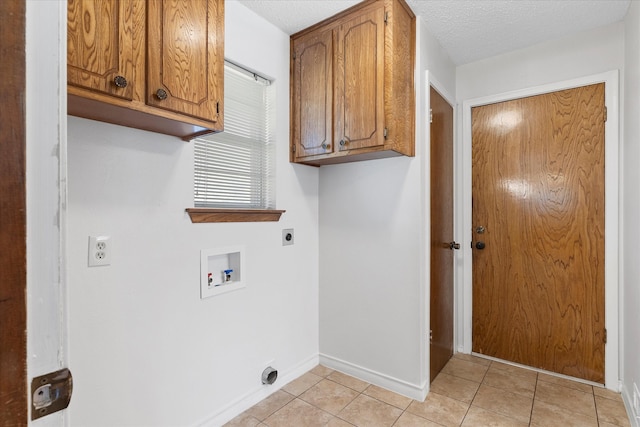 laundry room featuring cabinets, hookup for a washing machine, light tile patterned floors, and electric dryer hookup