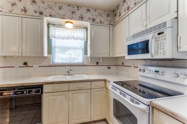 kitchen featuring tasteful backsplash, white appliances, sink, and light tile patterned flooring