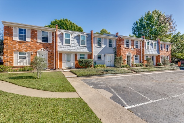 view of property featuring a front lawn