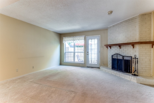 unfurnished living room featuring a textured ceiling, light colored carpet, and a fireplace