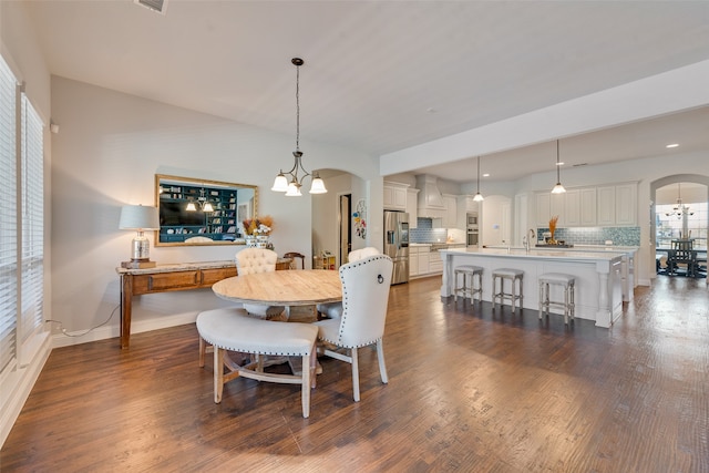 dining room with a chandelier, dark hardwood / wood-style floors, and sink