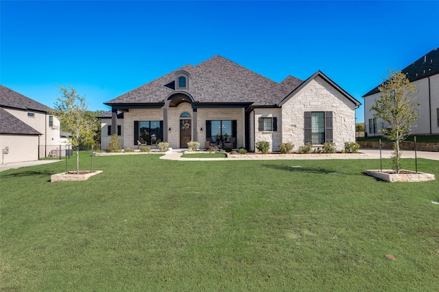 french country home with a front lawn