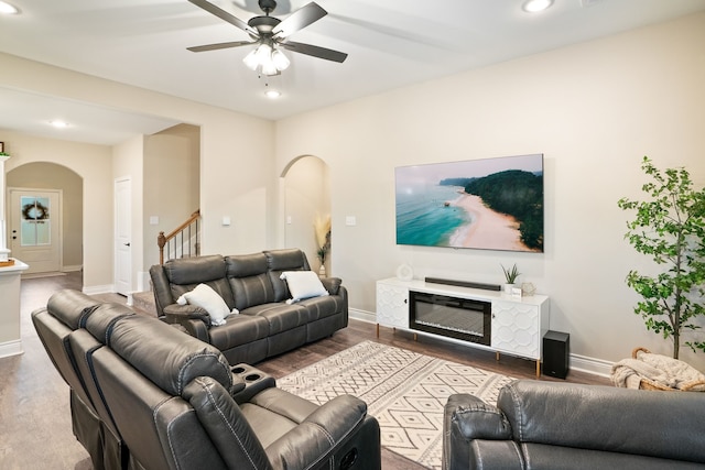 living room with wood-type flooring and ceiling fan