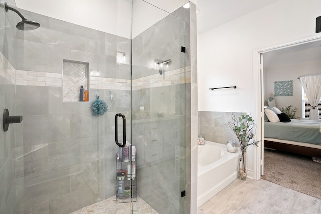 bathroom featuring hardwood / wood-style floors and plus walk in shower