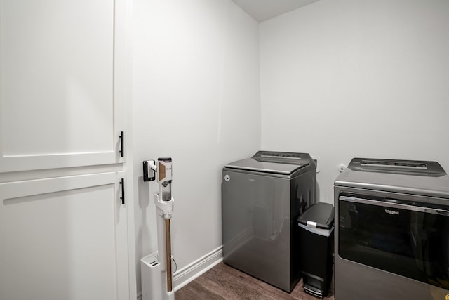 laundry room featuring dark wood-type flooring and separate washer and dryer