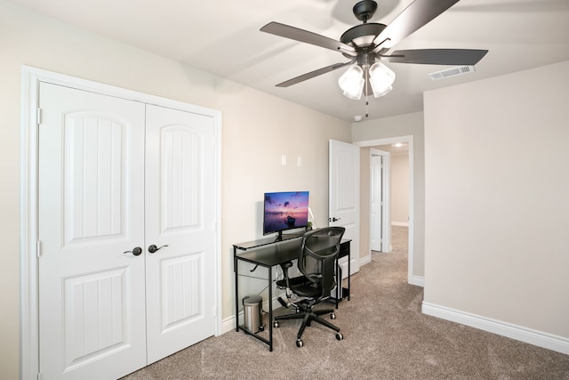 carpeted office space with ceiling fan