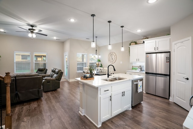 kitchen with pendant lighting, sink, a kitchen island with sink, white cabinetry, and appliances with stainless steel finishes