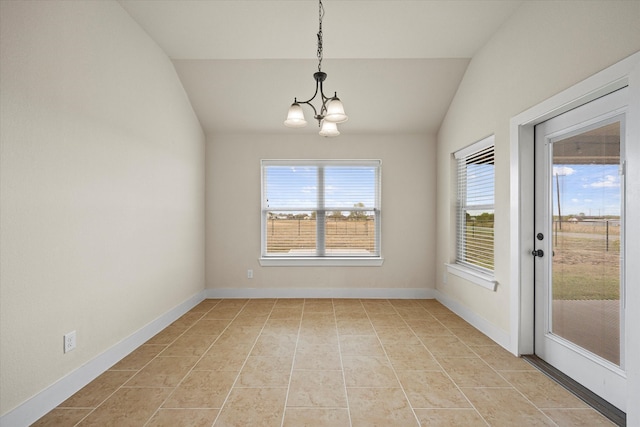 unfurnished dining area featuring plenty of natural light, light tile patterned floors, vaulted ceiling, and a notable chandelier