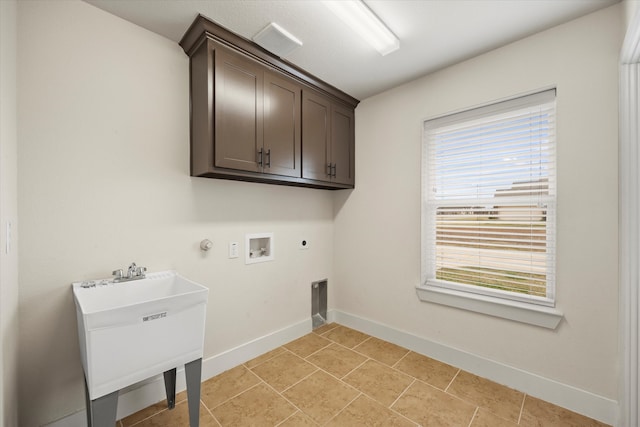 washroom featuring cabinets, light tile patterned flooring, washer hookup, hookup for an electric dryer, and gas dryer hookup