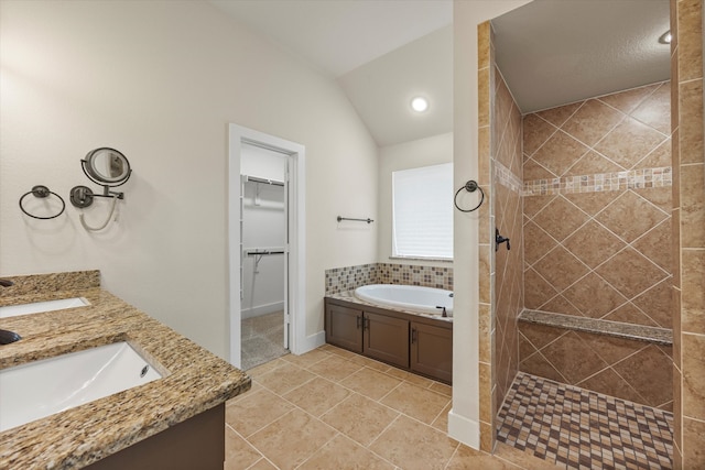 bathroom with vanity, a textured ceiling, independent shower and bath, tile patterned flooring, and lofted ceiling