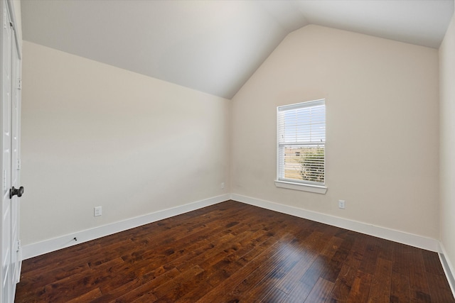 unfurnished room featuring dark hardwood / wood-style flooring and vaulted ceiling