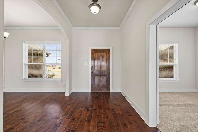 entrance foyer featuring ornamental molding and dark hardwood / wood-style floors