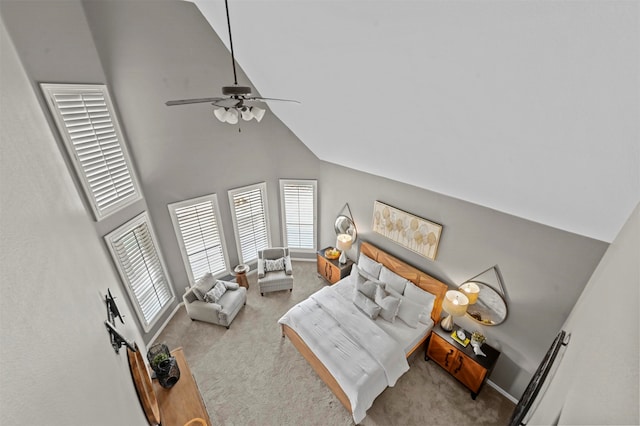 living room with high vaulted ceiling, light colored carpet, and ceiling fan