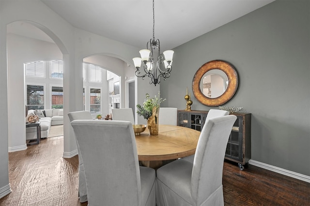 dining room featuring dark wood-type flooring and a notable chandelier