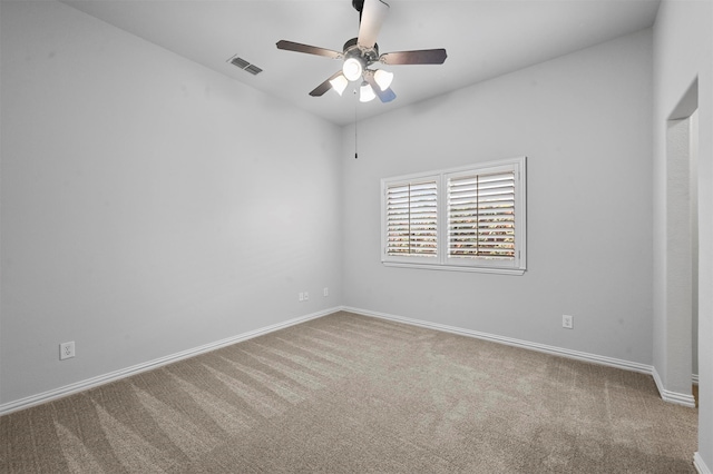 carpeted spare room with ceiling fan