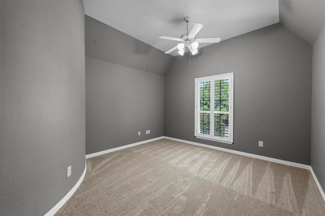 carpeted spare room with lofted ceiling and ceiling fan