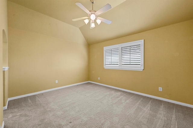 unfurnished room featuring carpet flooring, ceiling fan, and vaulted ceiling