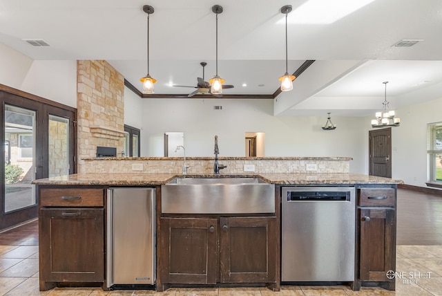 560 County Road 332, Abilene, TX 79606 - kitchen with stainless steel dishwasher, a sink, ceiling fan, dark brown cabinets, and pendant lighting