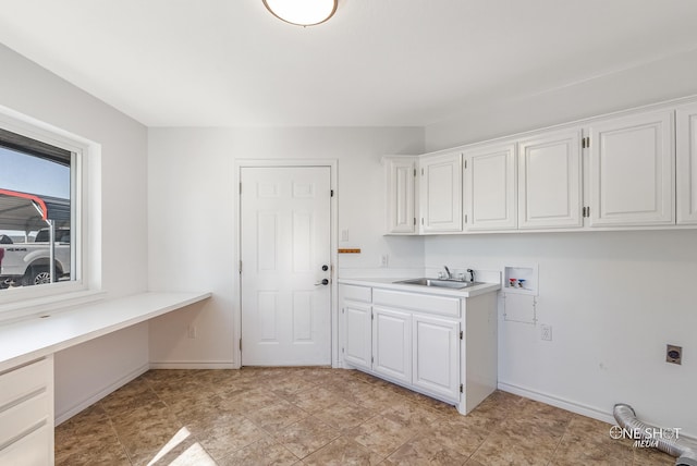 laundry area with cabinets, washer hookup, hookup for an electric dryer, and sink