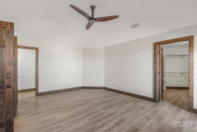 560 County Road 332, Abilene, TX 79606 - unfurnished bedroom with light wood-type flooring, baseboards, a spacious closet, ceiling fan, and vaulted ceiling