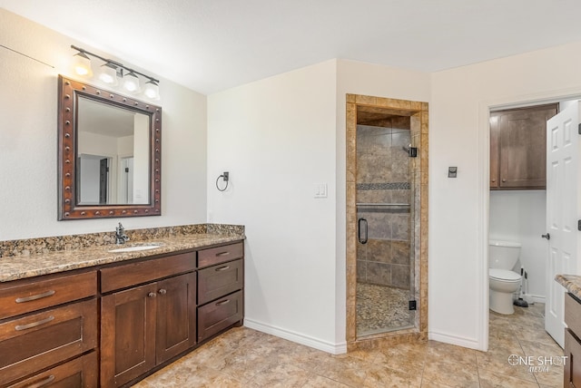 bathroom featuring toilet, vanity, tile patterned floors, and walk in shower