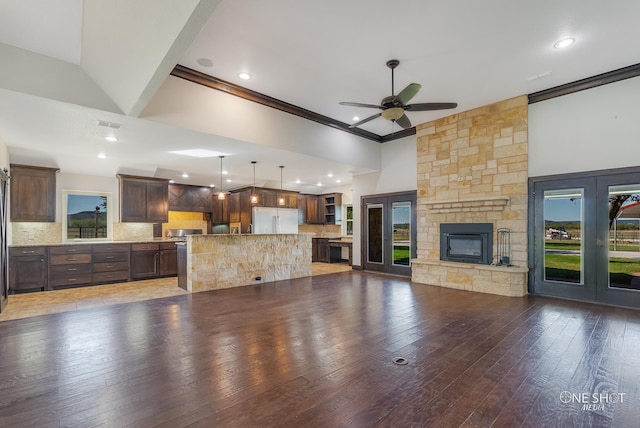 560 County Road 332, Abilene, TX 79606 - unfurnished living room featuring ceiling fan, light wood-type flooring, ornamental molding, recessed lighting, and a stone fireplace