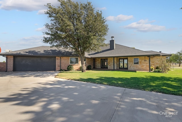 560 County Road 332, Abilene, TX 79606 - ranch-style home with a garage, concrete driveway, a chimney, stone siding, and a front lawn