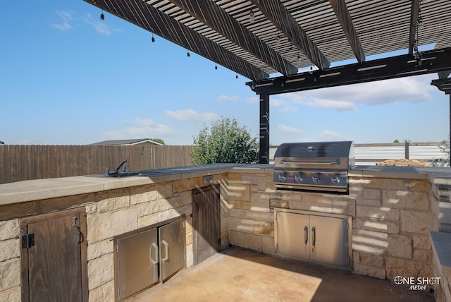 view of patio / terrace featuring an outdoor kitchen, a grill, a pergola, and sink