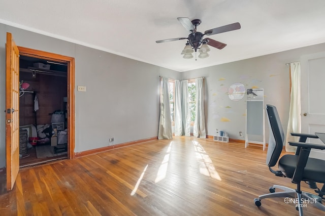 office space featuring ceiling fan, wood-type flooring, and ornamental molding