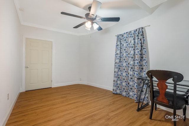 spare room featuring ceiling fan, light wood-type flooring, and ornamental molding