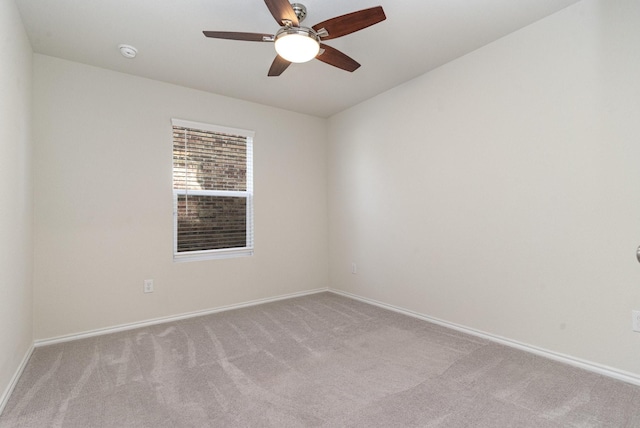 spare room with ceiling fan and light colored carpet