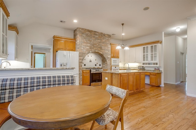 dining space with sink and light hardwood / wood-style flooring