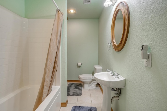 bathroom featuring toilet, shower / bath combo, and tile patterned floors