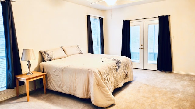 carpeted bedroom featuring access to outside, french doors, and ceiling fan