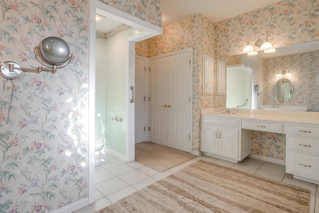 bathroom featuring vanity, tile patterned floors, and toilet