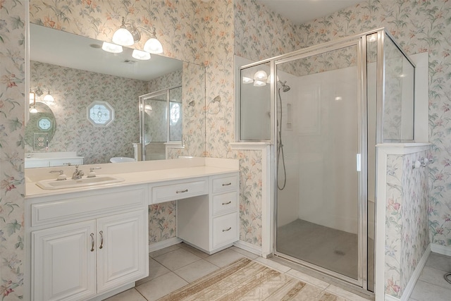 bathroom featuring walk in shower, tile patterned flooring, and vanity