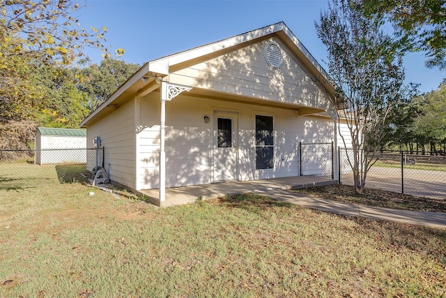 back of house with a lawn